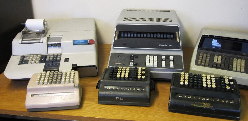 IMG_5041.JPG - A collection of calculators: left is the Olivettti Programma P101 bureau computer, in the middle the Canola 161 from 1965. In front are three mechanical key-punch calculators.                               