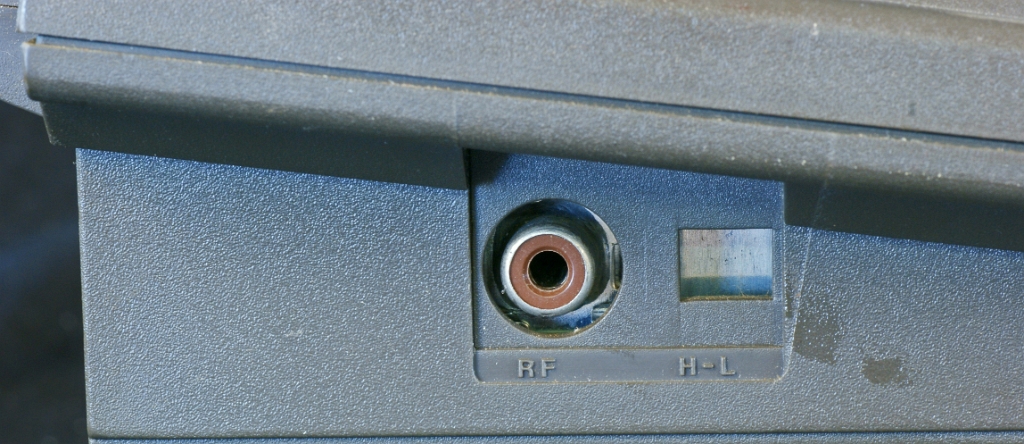 DSC03196.JPG - RF cinch socket to attach to TV airial. The H-L hole holds a switch to select either channel 3 or 4 on NTSC machines. The presence of the H-L hole shows that the case was probably imported for assembly.