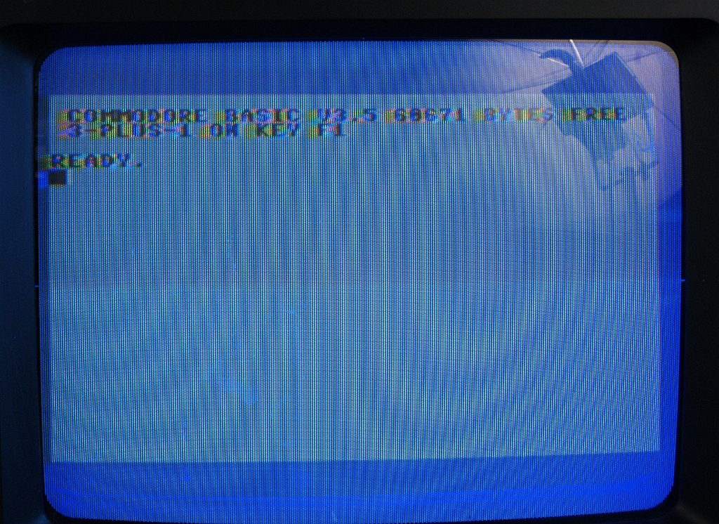 DSC03226.JPG - Boot screen shows "COMMODORE BASIC 3.5  60671 BYTES FREE. 3-PLUS-1 ON KEY F1". This means that F1 launches the 3-PLUS-1 Office Suite. The Moiré is an artifact of photography.