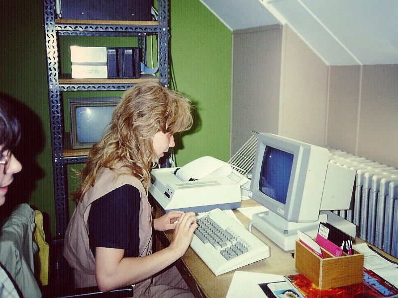 LCDinfo_1984.031.JPG - The rack at the back holds the SWTPc microcomputer (at the top, only half visible), a dual 5.25" floppy drive station and a B/W (actually green) monitor used for repairs. The student types on a  monitor communicating with the computer through a RS232 serial line