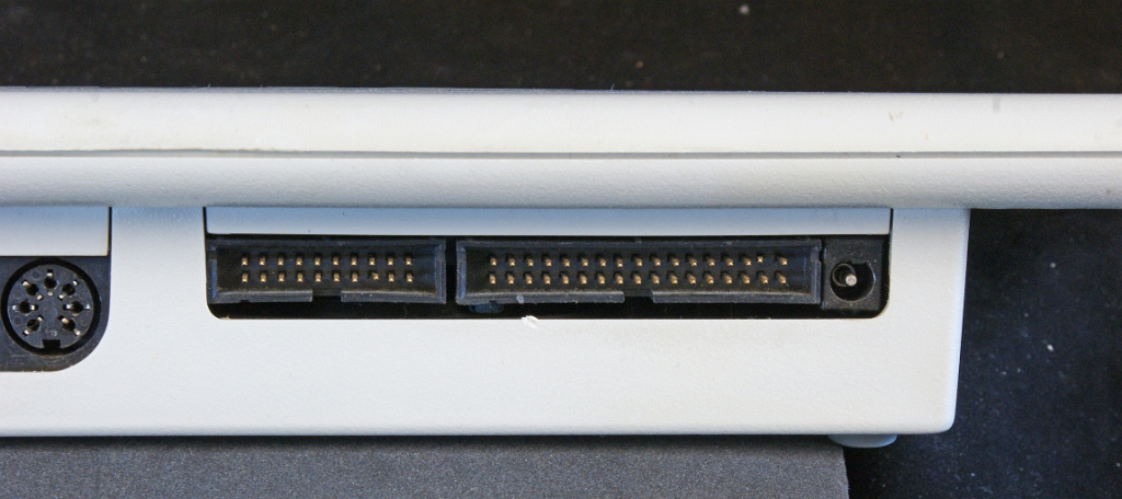 DSC03699.JPG - The two pin connectors for connecting a printer and floppy disks. The barrel connector at the right side accepts a single 9 VDC voltage.