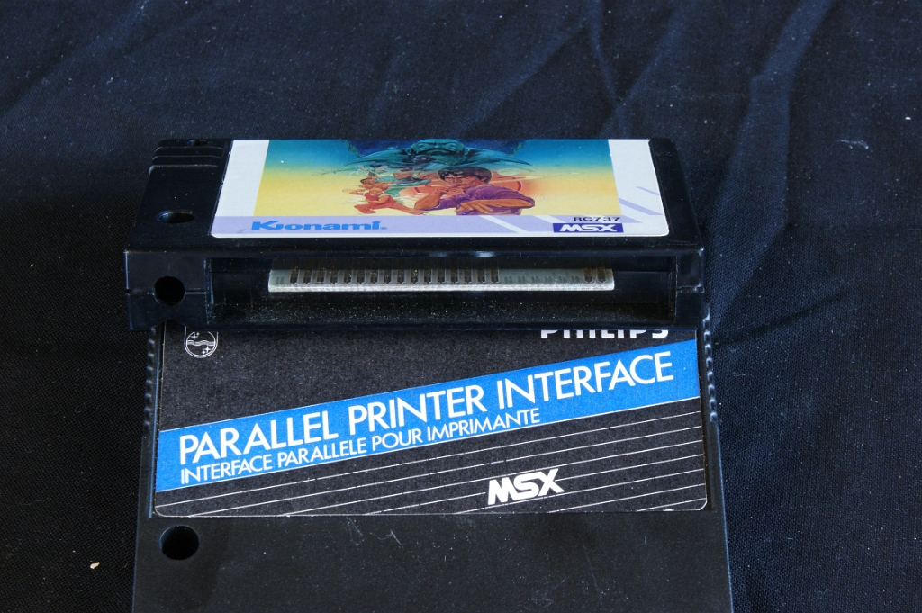 DSC03136.JPG - Two different cartridges: on top a game by Konami, and below a cartridge which gives the computer a parallel printer interface.