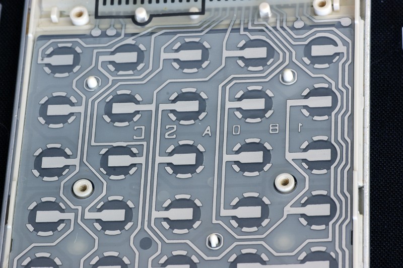 DSC07777.JPG - Close-up view on the membrane-type keyboard backplane. Note the complicated routing of the connecting traces.