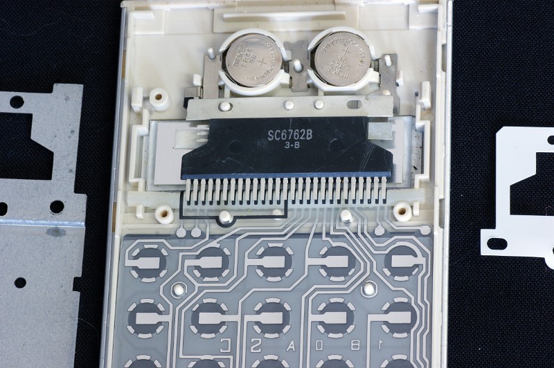 DSC07779.JPG - This picture shows that the chip is unsoldered, and its pins must be forcibly bent to make contact with the keyboard backplane. Note the unusual non-rectangular  shape of the chip and the unconnected pins at the higher left.